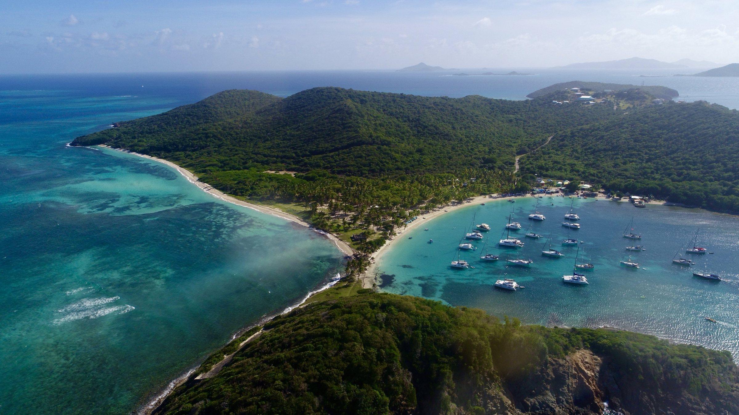 Aerial view of Salt Whistle Bay on Mayreau, with yachts at anchor and other Grenadine islands on the horizon